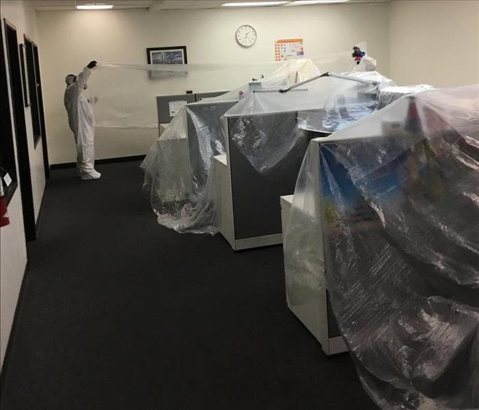 office desks covered in containement material to be disinfected