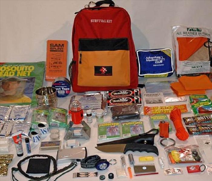 Emergency backpack with contents spewed across table